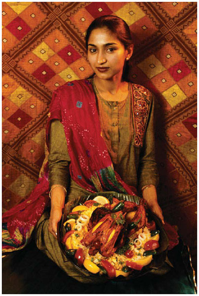 An Asian Indian woman from Rockville, Maryland, holds a tray of food, 1993.