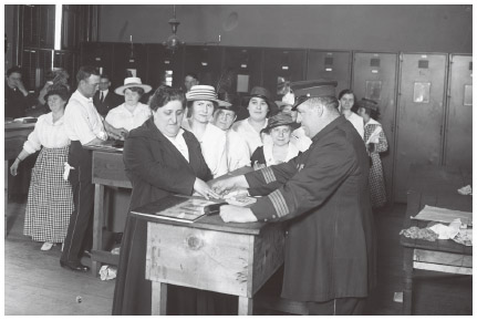 During World War I, German “aliens” living in New York City's “Little Germany” (Yorkville) line up to be fingerprinted and registered at the East 68th Street police station,