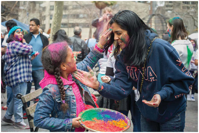 In Dag Hammarskjold Plaza in New York on Sunday, March 31, 2013, the spring holiday of Holi is celebrated by throwing and wearing colored powder.